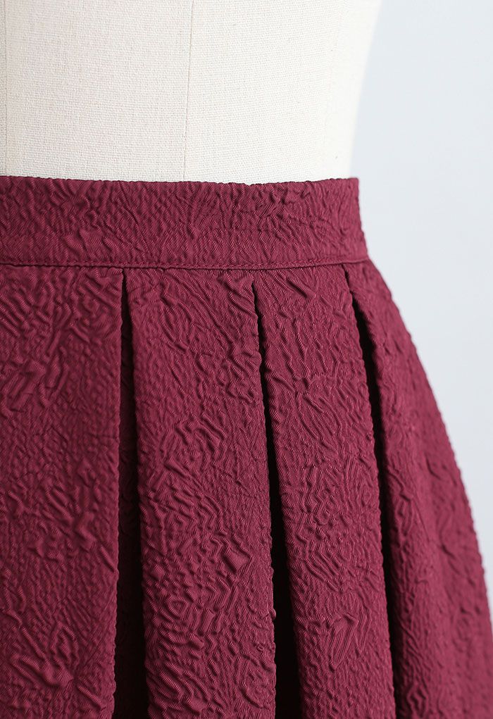 Carnation Embossed Satin Pleated Midi Skirt in Burgundy