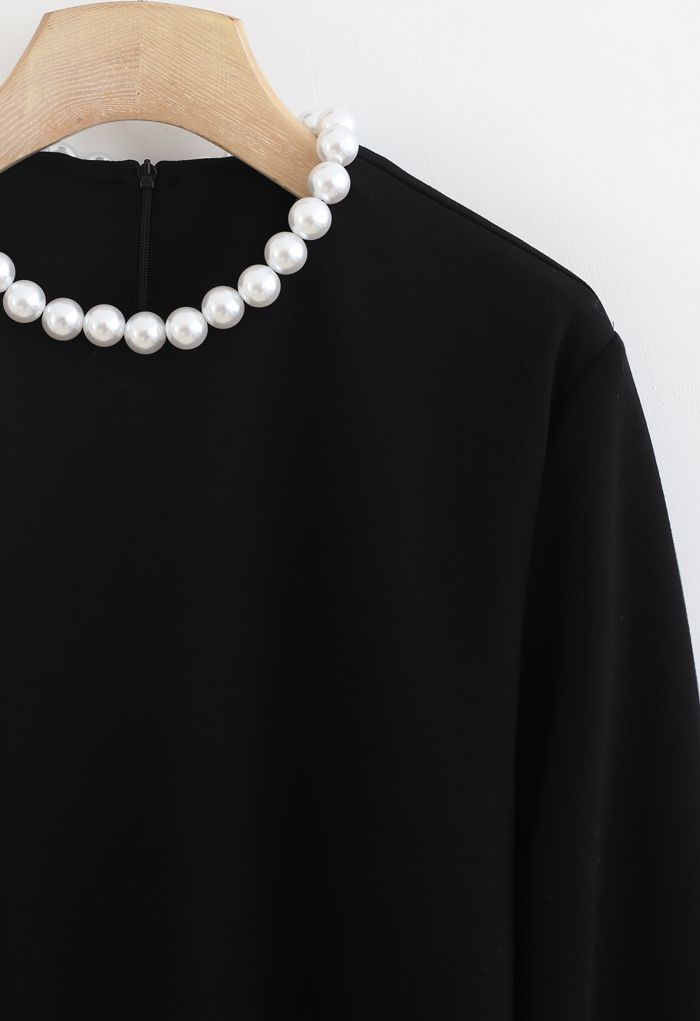 Pearly Neck Cross Wrap Hem Pullover in Black
